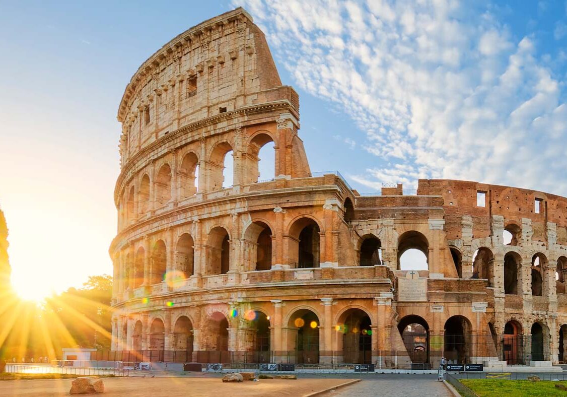Panoramic view of Colosseum in Rome and morning sun, Italy, Europe.