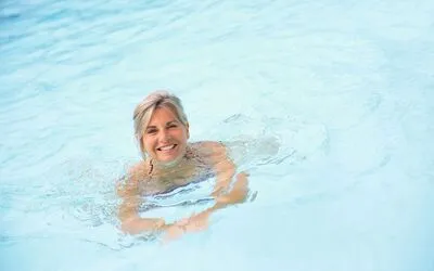 Cheerful senior woman in swimming-pool
