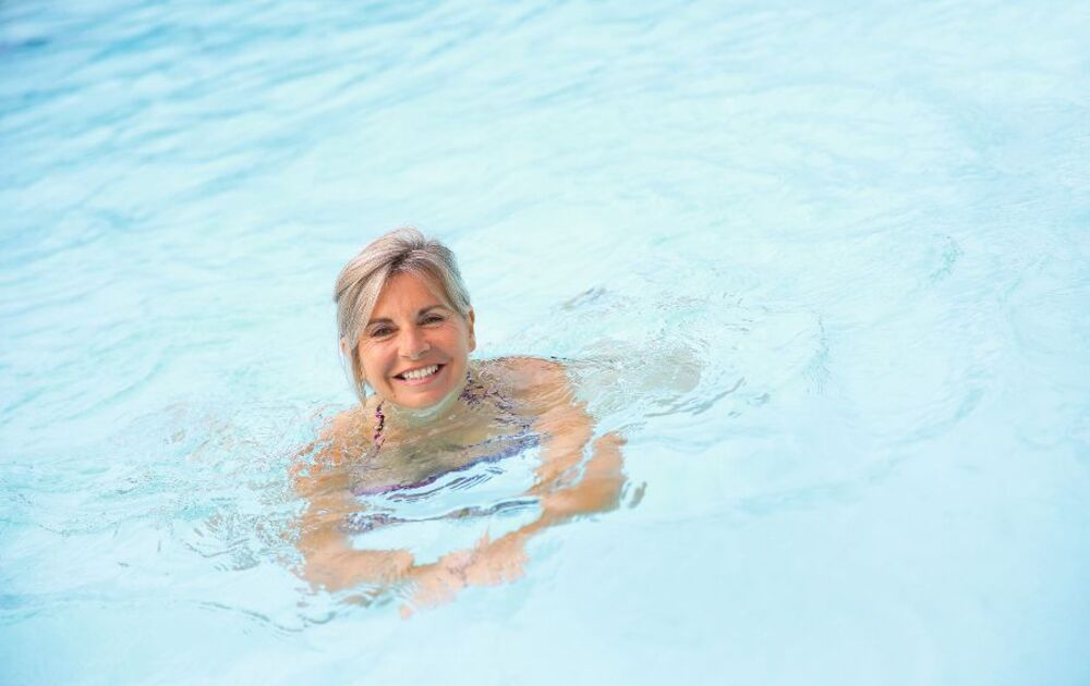 Cheerful senior woman in swimming-pool